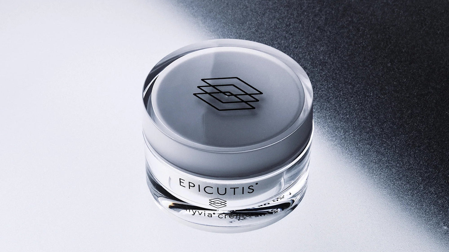 Epicutis cream jar on a reflective surface with a black background